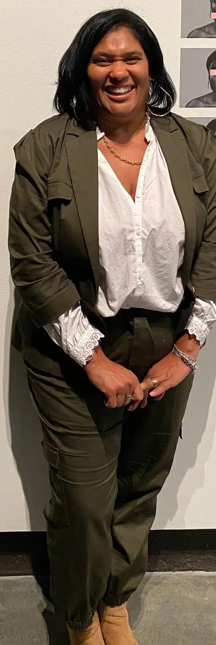 Beatrice Geiger-Williams smiling, in an olive suit and white blouse